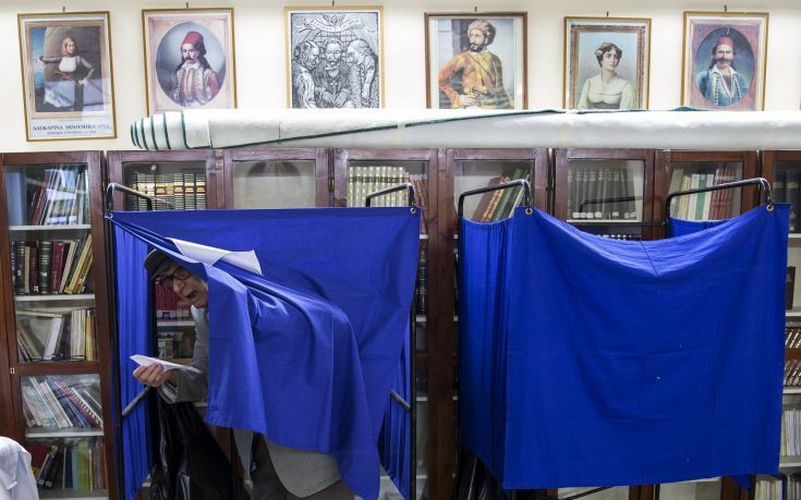 A man leaves polling booth to cast ballot during a referendum vote in Athens