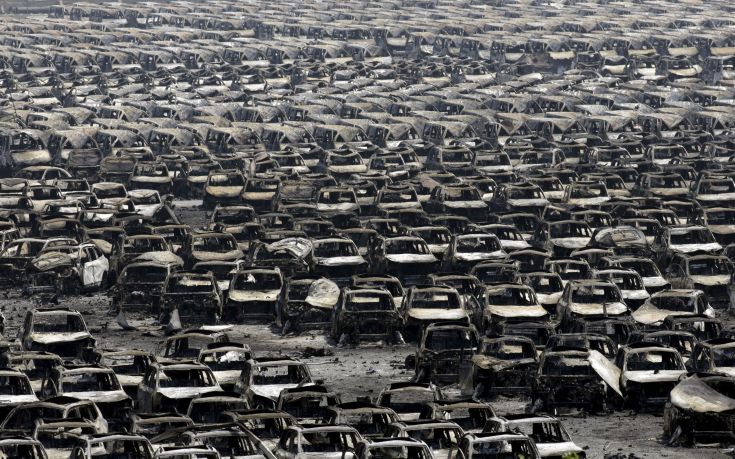 Damaged cars are seen near the site of the explosions at the Binhai new district, Tianjin, August 13, 2015. At least 17 people were killed and 400 injured when two huge explosions tore through an industrial area where toxic chemicals and gas were stored in the northeast Chinese port city of Tianjin, state media said on Thursday. REUTERS/Jason Lee