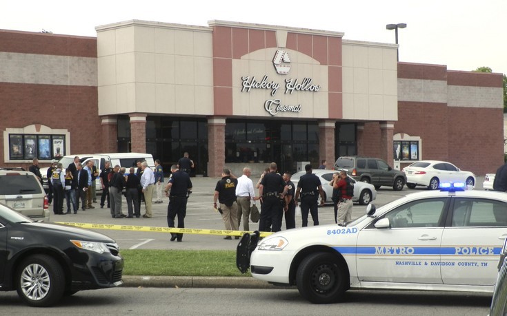 Emergency workers gather outside of a Nashville-area theater where a gunman wearing a surgical mask opened fire at a showing of the movie "Mad Max: Fury Road" in Nashville, Tennessee August 5, 2015. The gunman was fatally shot by police and three people in the theater suffered minor injuries after the suspect sprayed a substance thought to be pepper spray.   REUTERS/Tim Ghianni