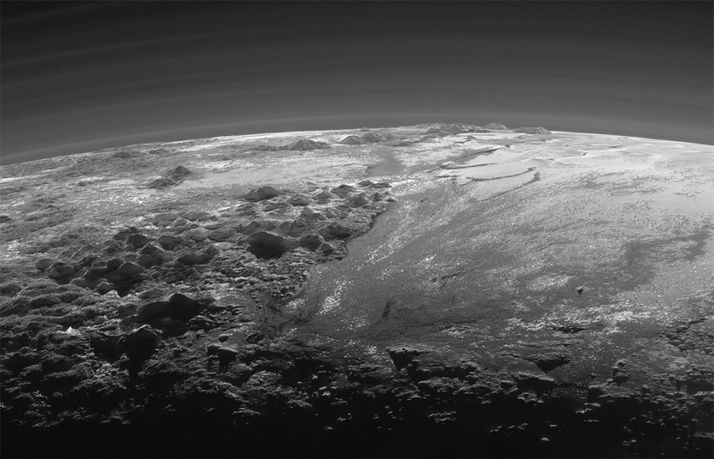 A close-up view of the rugged, icy mountains and flat ice plains on Pluto is seen in an image from NASA's New Horizons spacecraft taken July 14, 2015 and released September 17, 2015. The expanse of the informally named icy plain Sputnik Planum (R) is flanked to the west (L) by rugged mountains up to 11,000 feet (3,500 meters) high. The image was taken from a distance of 11,000 miles (18,000 kilometers) to Pluto.  REUTERS/NASA/JHUAPL/SwRI/Handout via Reuters