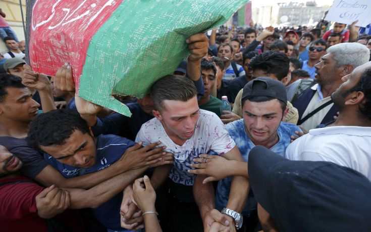 A group of migrants tries to make their way through the crowd to the Eastern railway station in Budapest