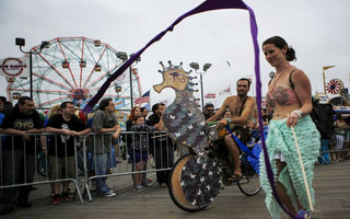Participants take part in the Mermaid Parade along the boardwalk on Coney Island, in Brooklyn, New York, June 20, 2015. The annual parade, founded in 1983, seeks to bring mythology to life for residents, create confidence in the district and to allow artistic self-expression in public, according to the parade's website. REUTERS/Eduardo Munoz