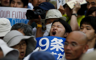 People shout slogans during anti-government rally in front of parliament in Tokyo