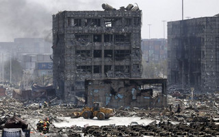 Damaged buildings and cars are seen near the site of the explosions at the Binhai new district, Tianjin, August 13, 2015. At least 17 people were killed and 400 injured when two huge explosions tore through an industrial area where toxic chemicals and gas were stored in the northeast Chinese port city of Tianjin, state media said on Thursday. REUTERS/Jason Lee