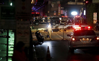 ATTENTION EDITORS - VISUAL COVERAGE OF SCENES OF DEATH AND INJURY The body of a victim covered with a sheet is seen as security forces and emergency workers gather at the scene of the blast in central Bangkok August 17, 2015. The bomb planted at one of the Thai capital's most renowned shrines on Monday killed 16 people, including three foreign tourists, and wounded scores in an attack the government called a bid to destroy the economy.  REUTERS/Chaiwat SubprasomTEMPLATE OUT