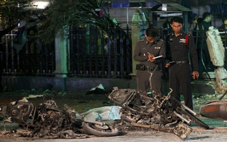 Experts investigate the remains of destroyed motorcycles at the Erawan shrine, the site of the blast in central Bangkok August 17, 2015. The bomb planted at one of the Thai capital's most renowned shrines on Monday killed 16 people, including three foreign tourists, and wounded scores in an attack the government called a bid to destroy the economy. REUTERS/Kerek Wongsa