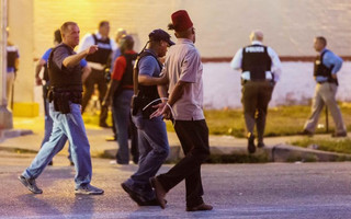Police arrest a man as protesters gathered after a shooting incident in St. Louis