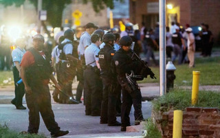 Police line up to block the street as protesters gathered after a shooting incident in St. Louis