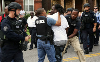 Police arrest a protester that was in the middle of the street after a shooting incident in St. Louis