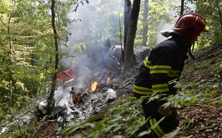 Firefighter inspects the crash site of two sport planes near the village of Cerveny Kamen, Slovakia