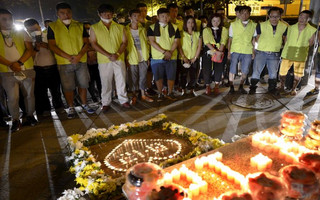 Residents and volunteers attend a candlelight vigil to mourn the victims of Wednesday night's explosions, outside a hospital at Binhai new district in Tianjin