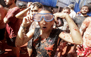Revelers leave the "battlefield" after the annual "Tomatina" (tomato fight) in Bunol, near Valencia