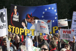 Consumer rights activists take part in a march to protest against the Transatlantic Trade and Investment Partnership (TTIP), mass husbandry and genetic engineering, in Berlin, Germany, October 10, 2015. The European Union is pursuing a trade accord with the United States, called the Transatlantic Trade and Investment Partnership (TTIP), that would encompass a third of world trade and nearly half of global GDP.         REUTERS/Fabrizio Bensch