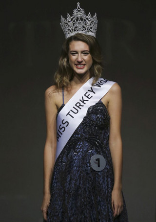 In this photo taken on Thursday, Sept. 21, 2017, Itir Esen, 18, smiles after being crowned as Miss Turkey 2017 in Istanbul. Organizers have stripped Miss Turkey 2017 of her crown over a social media posting that was deemed insulting to the memory of some 250 people who were killed while opposing last year's failed military coup. Miss Turkey organizers said Esen was dethroned on Friday - a day after she won the contest and the right to represent Turkey at the Miss World contest in China - over a tweet they described as "unacceptable." (AP Photo)