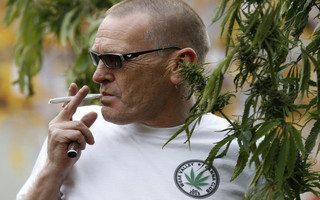 Fraser Lightbody from Teesside Cannabis Club poses with a Hemp plant during a cannabis rally near Parliament in London, Tuesday, Oct. 10, 2017. The rally was to help raise awareness of the medical use of cannabis.(AP Photo/Kirsty Wigglesworth)