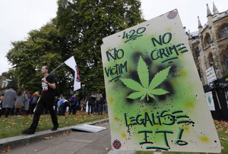 A banner stands in the ground during a rally in London, Tuesday, Oct. 10, 2017. The rally was to help raise awareness of the medical use of cannabis. (AP Photo/Kirsty Wigglesworth)