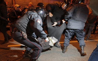 Riot police officers detain a protester during a rally in St.Petersburg, Russia, Saturday, Oct. 7, 2017. Supporters of opposition leader Alexei Navalny rallied across Russia on Saturday, heeding his call to pressure authorities into letting him enter the presidential race with a wave of demonstrations on President Vladimir Putin's 65th birthday. (AP Photo/Dmitri Lovetsky)