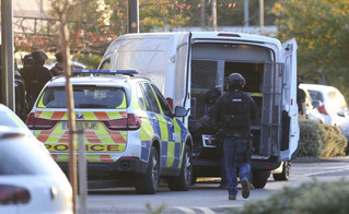 Police at the scene at Bermuda Park in Nuneaton, central England, where they are dealing with an ongoing incident, Sunday Oct. 22, 2017. A police department in central England says a reported hostage-taking incident at a bowling alley is "unconnected to any terrorist activity." (Aaron Chown/PA via AP)