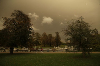 Hyde Park is bathed in a dull sepia light from the sky in London, Monday, Oct. 16, 2017. The unusual hue of the daylight sky was thought to be due to the remnants of Hurricane Orphelia dragging in tropical air and dust from the Sahara. (AP Photo/Matt Dunham)