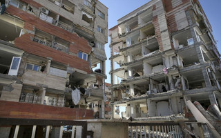 Buildings are damaged by an earthquake in a compound which was built under the Mehr state-owned program, in Sarpol-e-Zahab in western Iran, Tuesday, Nov. 14, 2017. Iran's President Hassan Rouhani says his administration will probe the cause of so much damage to buildings constructed under the Mehr program after a powerful earthquake hit the area along the border with Iraq on Sunday which killed over 400 people. (AP Photo/Vahid Salemi)