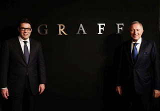 FILE - In this Monday, May 21, 2012 file photo, Graff Diamonds Founder and Chairman Laurence Graff, right, and CEO Francois Graff stands before attending an IPO roadshow in Hong Kong. The London jeweler said Thursday, May 31, 2012 in a brief statement that it's postponing plans to go public in the southern Chinese financial center because of the recent downturn in global financial markets. Graff Diamonds would have been the latest in a line of foreign luxury brands to sell shares in Hong Kong. (AP Photo/Vincent Yu, File)