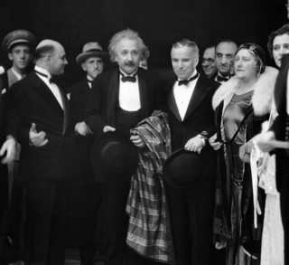 Dr. Albert Einstein, center, a German physicist, stands with his wife Elsa Einstein, and Charles Chaplin, second right, as they arrive for the opening of Chaplin's silent movie, in Los Angeles, Calif., Feb. 2, 1931. (AP Photo)