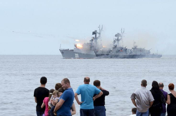 People gather to watch celebrations for Navy Day, as a Russian warship fires, in the far eastern city of Vladivostok People gather to watch celebrations for Navy Day, as a Russian warship fires, in the far eastern city of Vladivostok