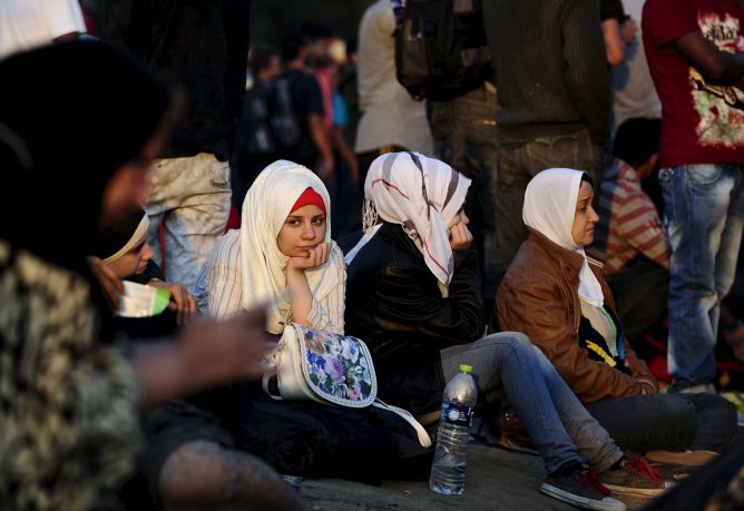 A new group of immigrants wait at the border line of Macedonia and Greece to enter into Macedonia A new group of immigrants wait at the border line of Macedonia and Greece to enter into Macedonia