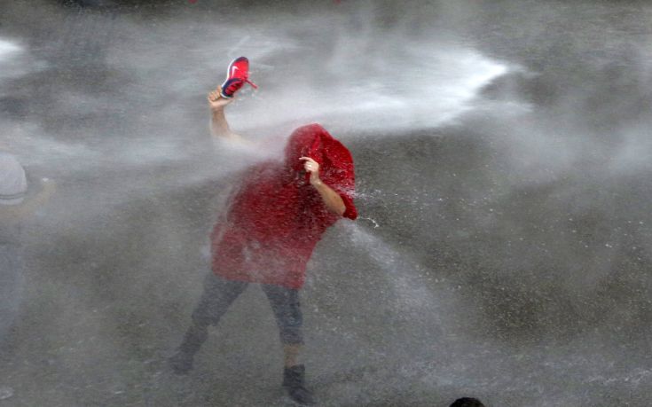 A Lebanese protester is sprayed with water during a protest against corruption and rubbish collection problems near the government palace in Beirut A Lebanese protester is sprayed with water during a protest against corruption and rubbish collection problems near the government palace in Beirut