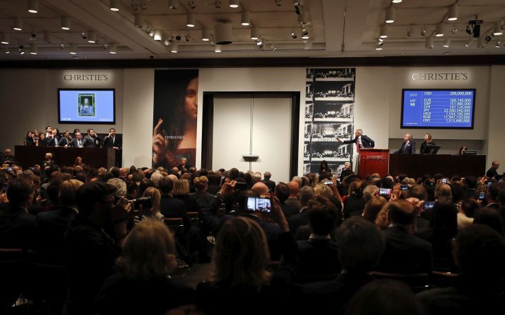 CORRECTS PRICE - Christie's auctioneer Jussi Pylkannen, third from right, looks for another bid for Leonardo da Vinci's "Salvator Mundi" at Christie's, Wednesday, Nov. 15, 2017, in New York. The painting sold at $450 million. (AP Photo/Julie Jacobson) CORRECTS PRICE - Christie's auctioneer Jussi Pylkannen, third from right, looks for another bid for Leonardo da Vinci's "Salvator Mundi" at Christie's, Wednesday, Nov. 15, 2017, in New York. The painting sold at $450 million. (AP Photo/Julie Jacobson)