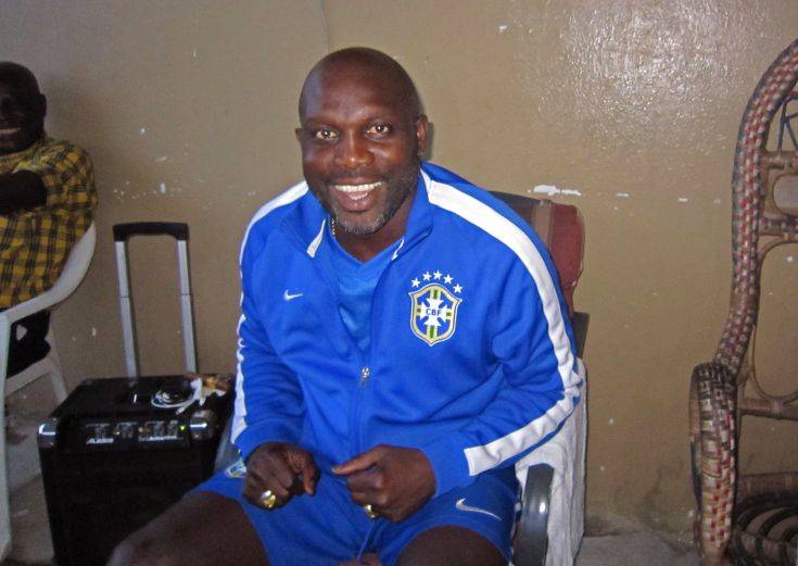 In this photo taken on Sunday, Aug. 10,  2014,  Liberian soccer star George Weah smiles inside a room in the city of  Monrovia, Liberia. Liberias world famous soccer star George Weah has produced a song to raise awareness about Ebola, the deadly disease ravaging West Africa. Weah, who before he retired was FIFAs player of the year, is now a politician and singer.(AP Photo/Jonathan Paye-Layleh)