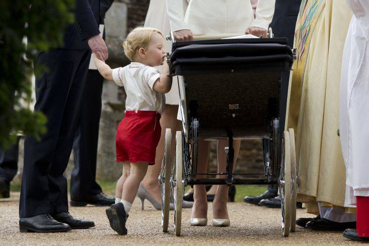 FILE - In this Sunday, July 5, 2015 file photo, Britain's Prince George gets up on tiptoes to peek into the pram of Princess Charlotte flanked by his parents Prince William and Kate the Duchess of Cambridge as they leave after Charlotte's Christening at St. Mary Magdalene Church in Sandringham, England. 33-year-old Pippa Middleton is marrying wealthy financier James Matthews in the village of Englefield, west of London on Saturday May 20, 2017, with a guest list of young A-list royals and reality TV stars looking on. (AP Photo/Matt Dunham, file)