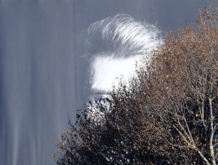 A huge poster of French rock star Johnny Hallyday hangs on the Madeleine church, in Paris, Saturday, Dec.9, 2017. France is bidding farewell to its biggest rock star, honoring Johnny Hallyday with an exceptional funeral procession down the Champs-Elysees, a presidential speech and a motorcycle parade, all under intense security. (AP Photo/Christophe Ena)