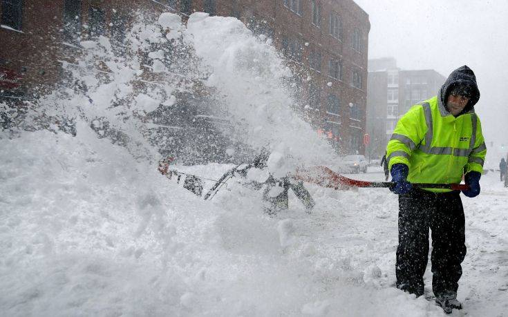 Workers clear snow from a sidewalk in the Seaport District of Boston, Thursday, Jan. 4, 2018. Forecasts for the Boston area call for about a foot of snow during the day and blizzard-like conditions.(AP Photo/Charles Krupa) Workers clear snow from a sidewalk in the Seaport District of Boston, Thursday, Jan. 4, 2018. Forecasts for the Boston area call for about a foot of snow during the day and blizzard-like conditions.(AP Photo/Charles Krupa)