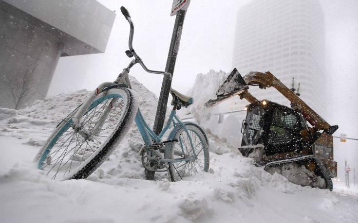 A bicycle is locked to a pole as a loader dumps snow onto a pile while clearing sidewalks in Boston, Thursday, Jan. 4, 2018. Forecasts for the Boston area call for about a foot of snow during the day and blizzard-like conditions. (AP Photo/Charles Krupa) A bicycle is locked to a pole as a loader dumps snow onto a pile while clearing sidewalks in Boston, Thursday, Jan. 4, 2018. Forecasts for the Boston area call for about a foot of snow during the day and blizzard-like conditions. (AP Photo/Charles Krupa)