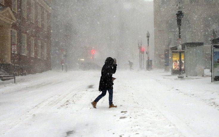 A pedestrian crosses the street in downtown Boston, Thursday, Jan. 4, 2018. A massive winter storm swept from the Carolinas to Maine on Thursday, dumping snow along the coast and bringing strong winds that will usher in possible record-breaking cold. (AP Photo/Michael Dwyer) A pedestrian crosses the street in downtown Boston, Thursday, Jan. 4, 2018. A massive winter storm swept from the Carolinas to Maine on Thursday, dumping snow along the coast and bringing strong winds that will usher in possible record-breaking cold. (AP Photo/Michael Dwyer)