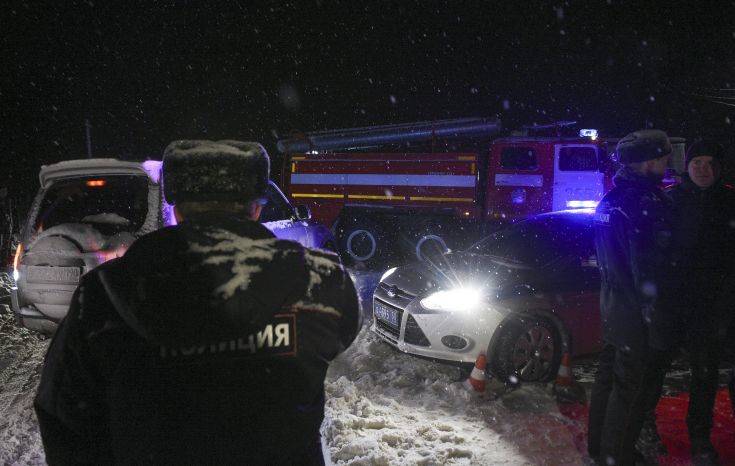 Police block the road to the scene of a AN-148 plane crash in Stepanovskoye village, about 40 kilometers (25 miles) from the Domodedovo airport, Russia, Sunday, Feb. 11, 2018. Russia's Emergencies Ministry says a passenger plane has crashed near Moscow and fragments of it have been found. Russian officials say all passengers aboard the airliner that has crashed outside Moscow are believed to have been residents of the region that was the plane's destination. No survivors have been reported. (AP Photo/Nikolay Koreshkov)