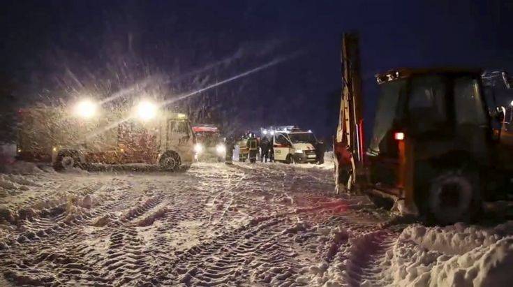 In this photo provided by the Russian Ministry for Emergency Situations RMES employees work at the scene of a AN-148 plane crash in Stepanovskoye village, about 40 kilometers (25 miles) from the Domodedovo airport, Moscow, Russia, Sunday, Feb. 11, 2018. The Saratov Airlines regional jet disappeared from radar screens a few minutes after departing from Domodedovo Airport en route to Orsk, a city some 1,500 kilometers (1,000 miles) southeast of Moscow. Russian officials say all passengers aboard the airliner are believed to have been residents of the region that was the plane's destination. No survivors have been reported. (Russian Ministry for Emergency Situations photo via AP)