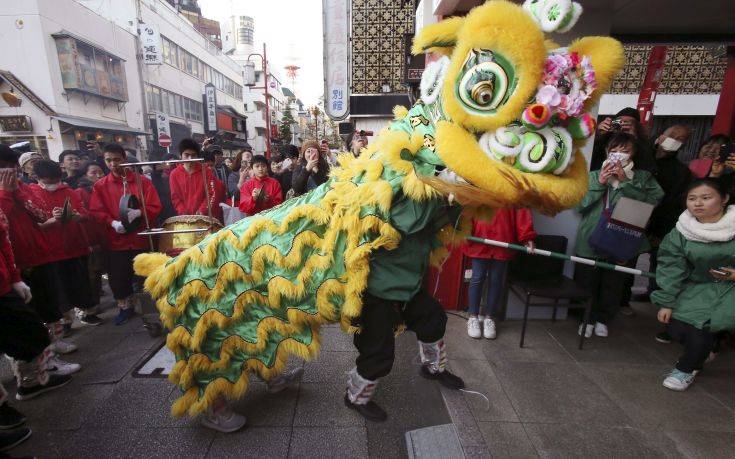 Lion dancers perform as they celebrate the Chinese Lunar New Year, parading through China Town in Yokohama, near Tokyo Friday, Feb. 16, 2018. (AP Photo/Koji Sasahara)