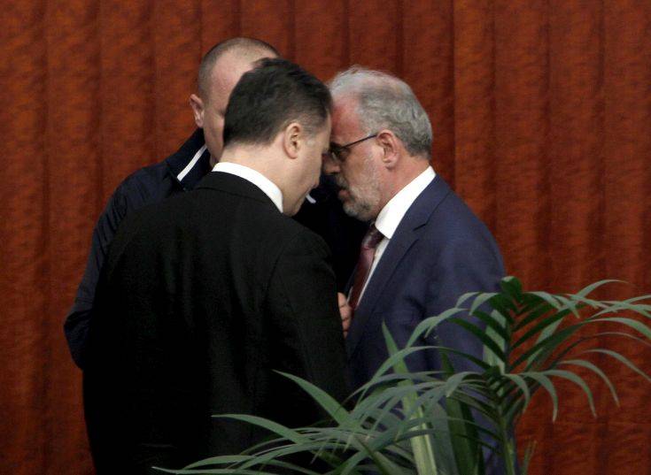 The lawmaker of the opposition VMRO DPMNE party Nikola Gruevski, left, confronts the parliament speaker Talk Xhaferi, right, during the voting for the law to make Albanian the second official language in the country, on a parliament session in Skopje, Macedonia, Wednesday, March 14, 2018. Macedonian parliament has approved for the second time the law making Albanian the second official language in the country after the country's president Gjorge Ivanov in January has vetoed the bill, describing it as unconstitutional and unnecessary.(AP Photo/Boris Grdanoski)