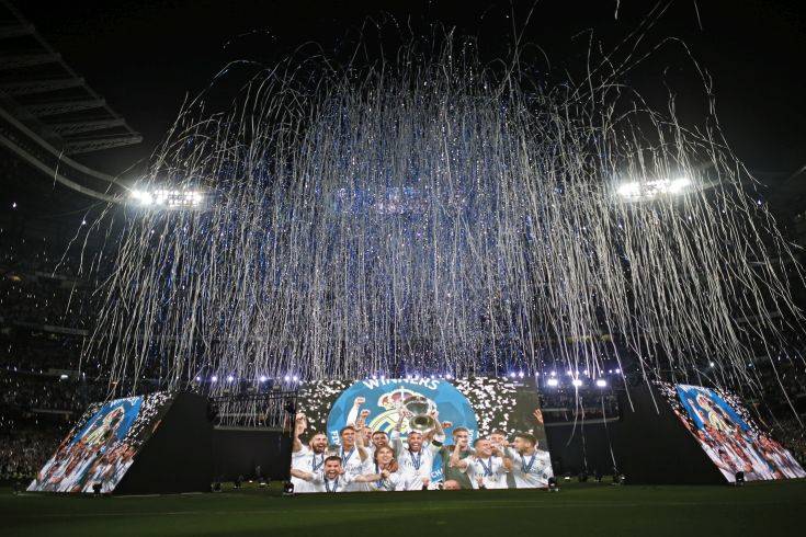 Real Madrid supporters watch on big screens placed at the team's Santiago Bernabeu stadium in Madrid, Spain, for the celebration of their team winning the Champions League final match against Liverpool played in Kiev, Ukraine,  Saturday, May 26, 2018. Real Madrid won 3-1. (AP Photo/Francisco Seco)