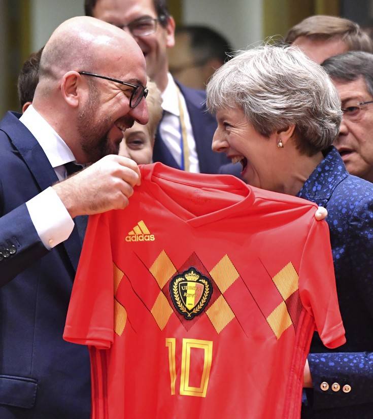 Belgian Prime Minister Charles Michel, left, presents a Belgian National Team jersey to British Prime Minister Theresa May during a round table meeting at an EU summit in Brussels, Thursday, June 28, 2018. European Union leaders meet for a two-day summit to address the political crisis over migration and discuss how to proceed on the Brexit negotiations. (AP Photo/Geert Vanden Wijngaert) Belgian Prime Minister Charles Michel, left, presents a Belgian National Team jersey to British Prime Minister Theresa May during a round table meeting at an EU summit in Brussels, Thursday, June 28, 2018. European Union leaders meet for a two-day summit to address the political crisis over migration and discuss how to proceed on the Brexit negotiations. (AP Photo/Geert Vanden Wijngaert)