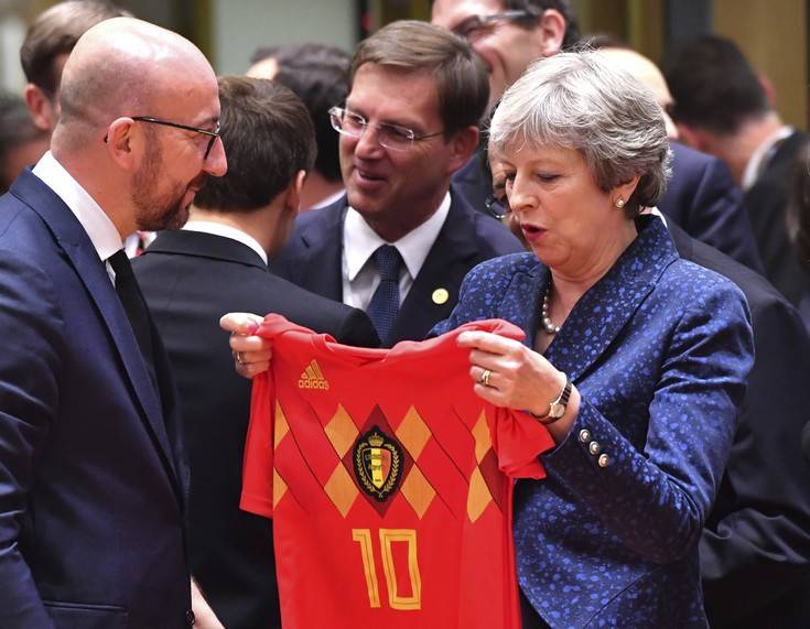 Belgian Prime Minister Charles Michel, left, presents a Belgian National Team jersey to British Prime Minister Theresa May during a round table meeting at an EU summit in Brussels, Thursday, June 28, 2018. European Union leaders meet for a two-day summit to address the political crisis over migration and discuss how to proceed on the Brexit negotiations. (AP Photo/Geert Vanden Wijngaert) Belgian Prime Minister Charles Michel, left, presents a Belgian National Team jersey to British Prime Minister Theresa May during a round table meeting at an EU summit in Brussels, Thursday, June 28, 2018. European Union leaders meet for a two-day summit to address the political crisis over migration and discuss how to proceed on the Brexit negotiations. (AP Photo/Geert Vanden Wijngaert)