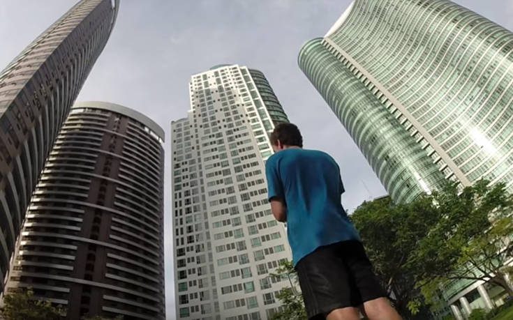 Παίζοντας με μια μπάλα μπάσκετ στην άκρη ενός ουρανοξύστη
