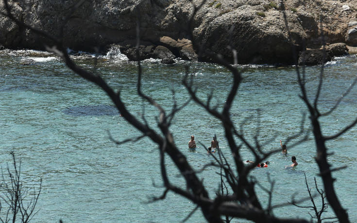 Λουόμενοι κάνουν μπάνιο στο λιμανάκι της Ραφήνας