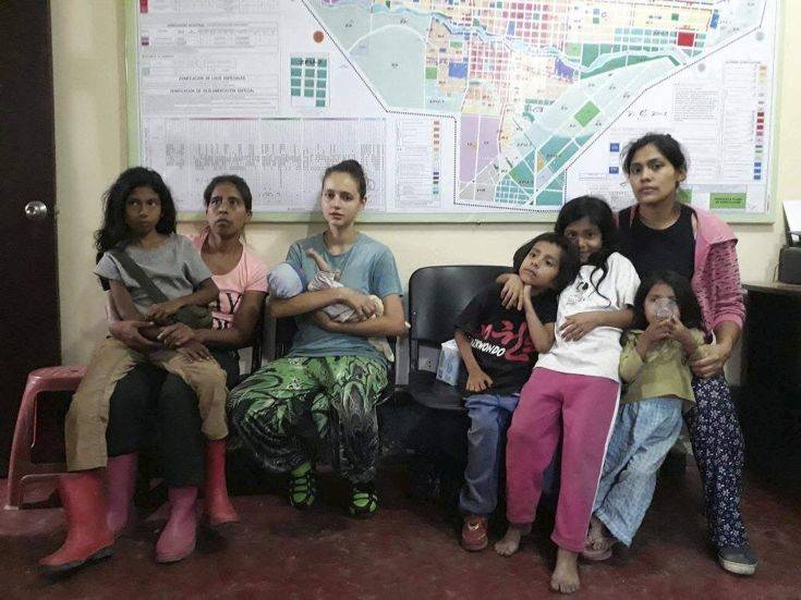 In this photo provided by Peru's police press office, Spanish citizen Patricia Aguilar, third from left, holds her baby at a police station, alongside two other Peruvian women and their children, after they were all rescued in San Martin de Pangoa, Peru, Thursday, July 5, 2018. Aguilar, a 19-year-old from Alicante, Spain, went missing in 2017 at age 16 and was rescued along with two Peruvian women while being held captive by Felix Manrique, a Peruvian who fathered their children. (Peru's police press office via AP) In this photo provided by Peru's police press office, Spanish citizen Patricia Aguilar, third from left, holds her baby at a police station, alongside two other Peruvian women and their children, after they were all rescued in San Martin de Pangoa, Peru, Thursday, July 5, 2018. Aguilar, a 19-year-old from Alicante, Spain, went missing in 2017 at age 16 and was rescued along with two Peruvian women while being held captive by Felix Manrique, a Peruvian who fathered their children. (Peru's police press office via AP)