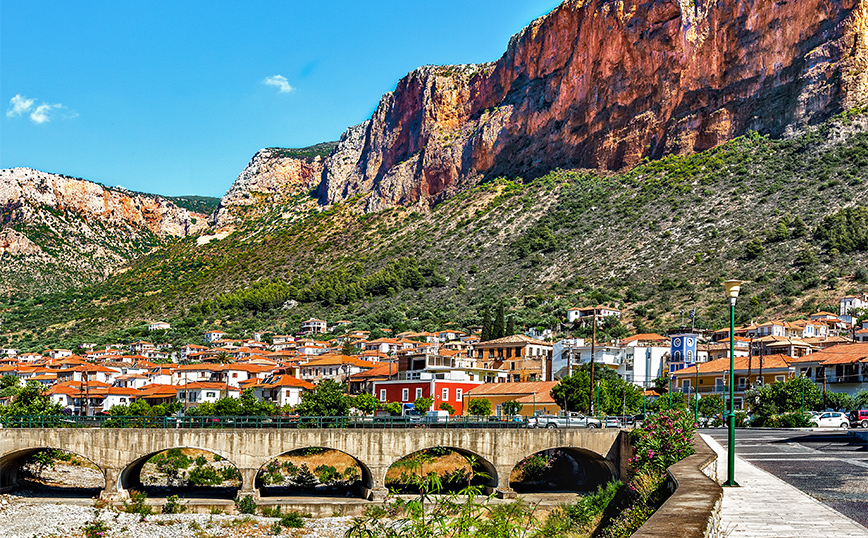 Το Λεωνίδιο και οι κόκκινοι βράχοι στο βάθος Το Λεωνίδιο και οι κόκκινοι βράχοι στο βάθος