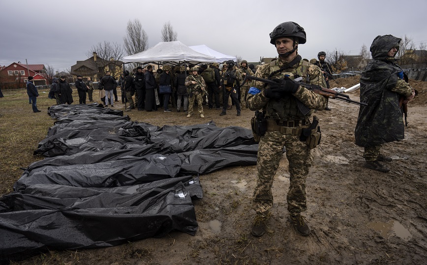 Soldiers stand guard as Ursula von der Leyen, European Commission President, visits a mass grave in Bucha, in the outskirts of Kyiv, Ukraine, Friday, April 8, 2022 Soldiers stand guard as Ursula von der Leyen, European Commission President, visits a mass grave in Bucha, in the outskirts of Kyiv, Ukraine, Friday, April 8, 2022