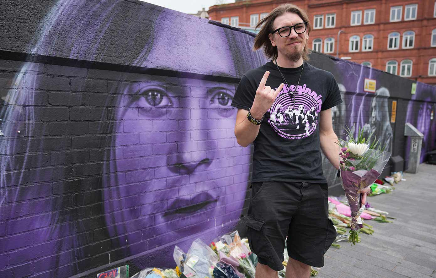 Flowers and messages are left by fans to commemorate the death of Ozzy Osbourne at the Black Sabbath Bridge in Birmingham