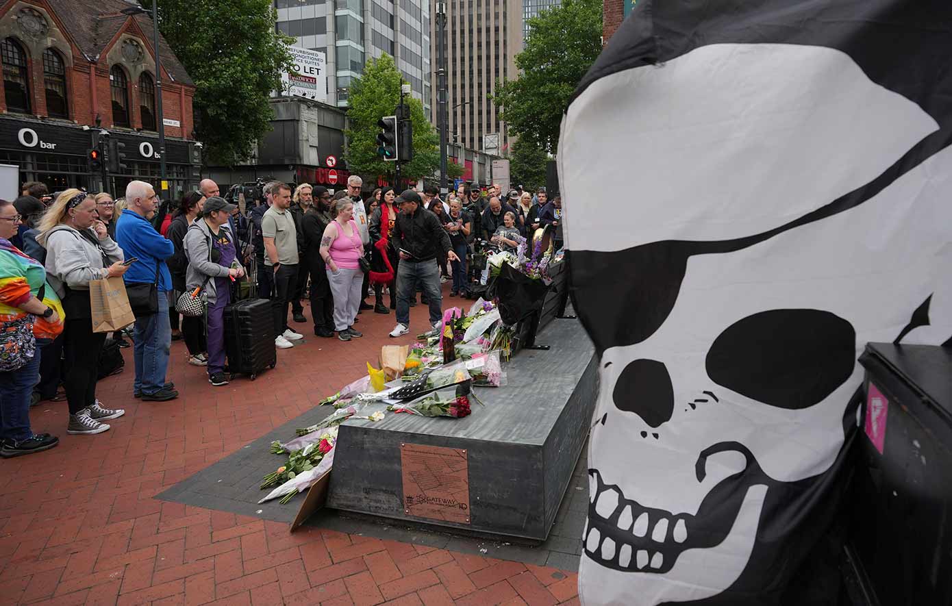Flowers and messages are left by fans to commemorate the death of Ozzy Osbourne at the Black Sabbath Bridge in Birmingham
